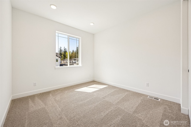 unfurnished room with carpet floors, baseboards, and visible vents