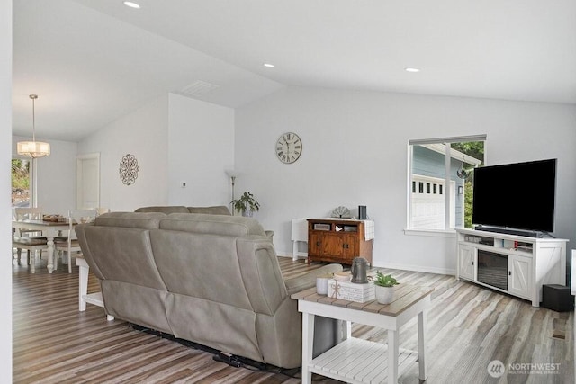 155 Baldwin Ln, Port Ludlow, WA 98365 - living area with light wood-style flooring, vaulted ceiling, a chandelier, and baseboards