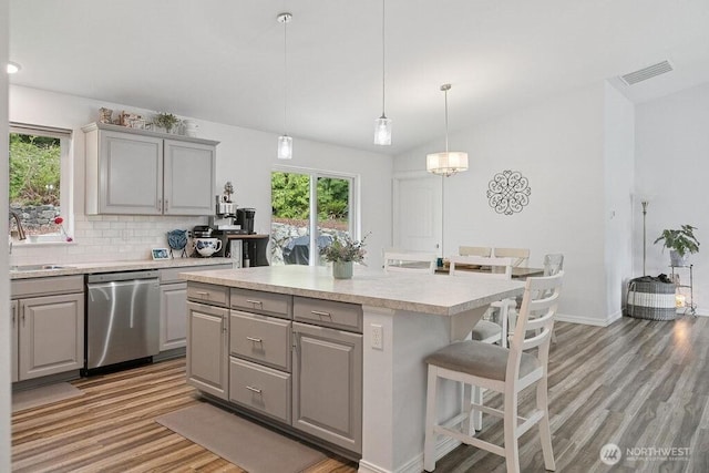 155 Baldwin Ln, Port Ludlow, WA 98365 - kitchen with dishwasher, gray cabinetry, light wood-type flooring, and lofted ceiling