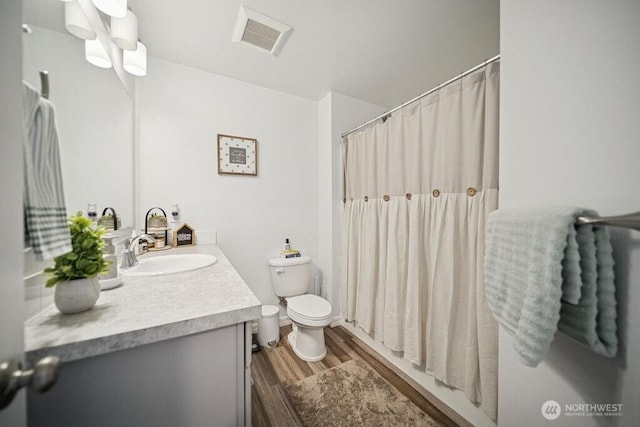 155 Baldwin Ln, Port Ludlow, WA 98365 - full bathroom featuring vanity, wood finished floors, toilet, and a shower with shower curtain