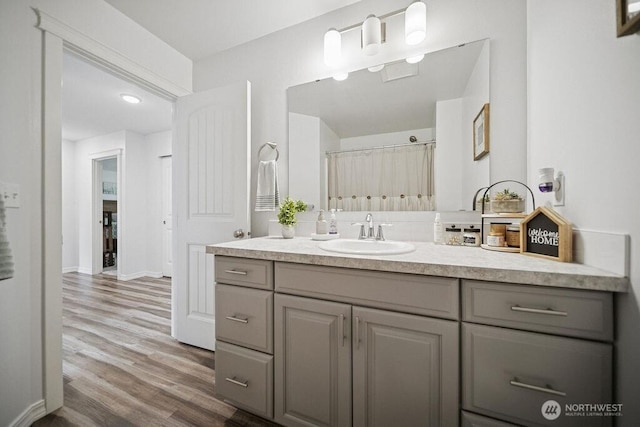 155 Baldwin Ln, Port Ludlow, WA 98365 - full bathroom featuring vanity, wood finished floors, baseboards, and curtained shower