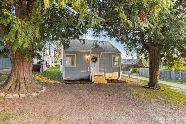 504 107th St S, Tacoma, WA 98444 - bungalow-style house featuring driveway, a carport, fence, a shingled roof, and entry steps