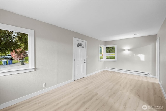 504 107th St S, Tacoma, WA 98444 - spare room featuring baseboards, a baseboard heating unit, and wood finished floors
