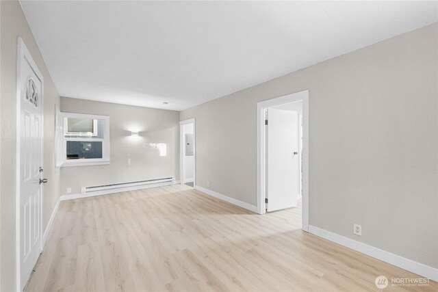 504 107th St S, Tacoma, WA 98444 - spare room with baseboards, a baseboard radiator, and light wood finished floors