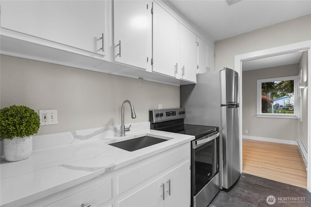 504 107th St S, Tacoma, WA 98444 - kitchen featuring light stone countertops, baseboards, white cabinets, stainless steel electric stove, and a sink