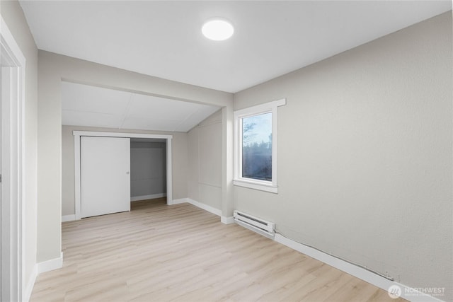 504 107th St S, Tacoma, WA 98444 - additional living space featuring vaulted ceiling, a baseboard heating unit, baseboards, and light wood finished floors