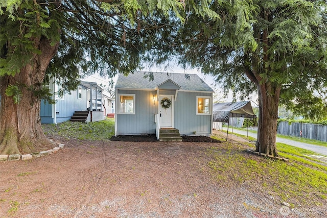 504 107th St S, Tacoma, WA 98444 - view of front of home featuring entry steps, fence, roof with shingles, and a detached carport