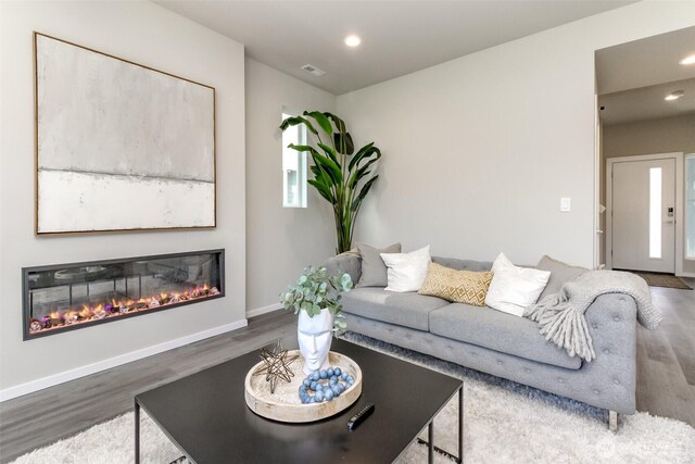 13826 Brookdale Ln E Unit 96, Tacoma, WA 98445 - living room featuring recessed lighting, a glass covered fireplace, wood finished floors, and visible vents