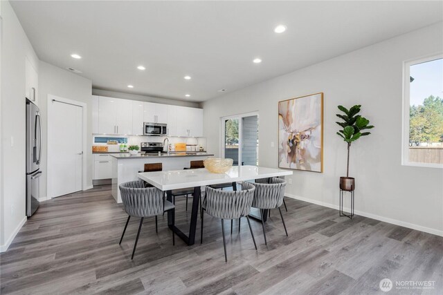 13826 Brookdale Ln E Unit 96, Tacoma, WA 98445 - dining space with recessed lighting, baseboards, and wood finished floors