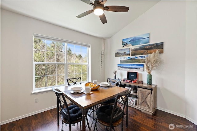 dining area with baseboards, ceiling fan, vaulted ceiling, and dark wood-type flooring