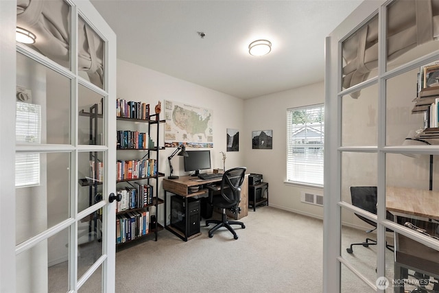 carpeted home office with french doors and baseboards