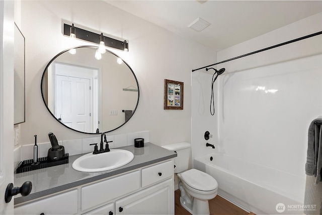 bathroom featuring visible vents,  shower combination, toilet, and vanity