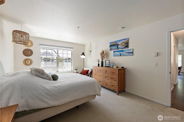 bedroom featuring carpet flooring and baseboards