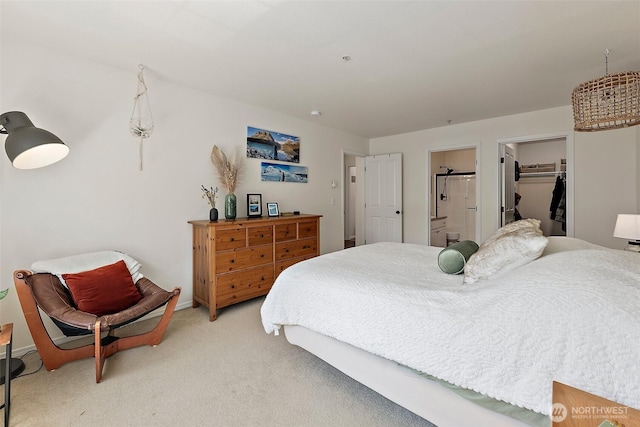 bedroom featuring connected bathroom, baseboards, and light colored carpet