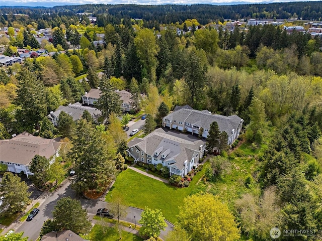 drone / aerial view with a residential view and a forest view