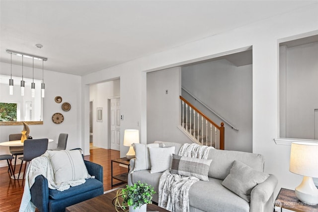 living room with stairway and wood finished floors