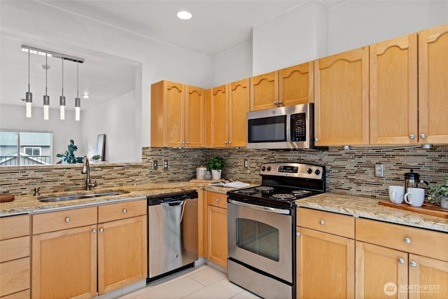 kitchen with a sink, light brown cabinets, and stainless steel appliances