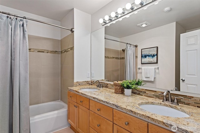 bathroom featuring a sink, decorative backsplash, shower / bathtub combination with curtain, and double vanity