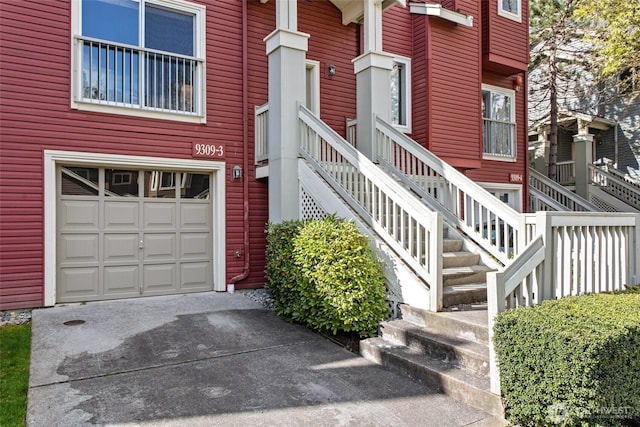 property entrance featuring an attached garage and driveway