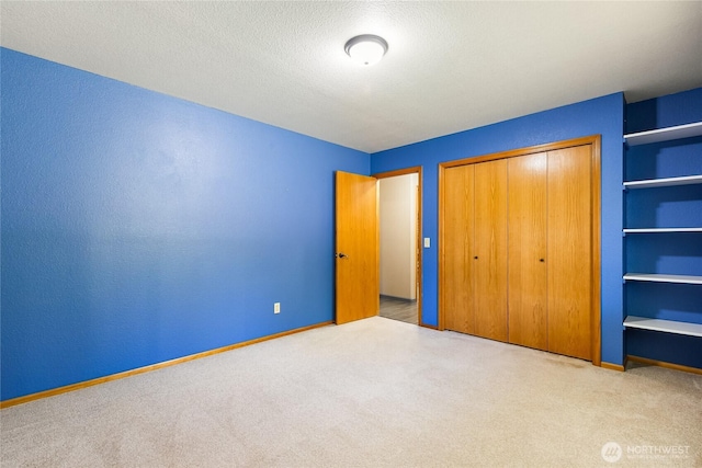 2995 Haynie Rd, Custer, WA 98240 - unfurnished bedroom featuring carpet flooring, a closet, baseboards, and a textured ceiling