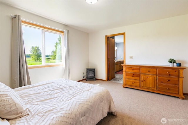 2995 Haynie Rd, Custer, WA 98240 - bedroom featuring light colored carpet, a wood stove, baseboards, and ensuite bathroom