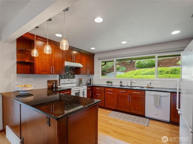 16631 Sylvester Rd SW, Burien, WA 98166 - kitchen featuring white appliances, under cabinet range hood, a peninsula, tasteful backsplash, and dark stone countertops