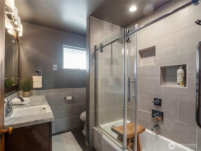 16631 Sylvester Rd SW, Burien, WA 98166 - full bath with tile walls, vanity, and bath / shower combo with glass door