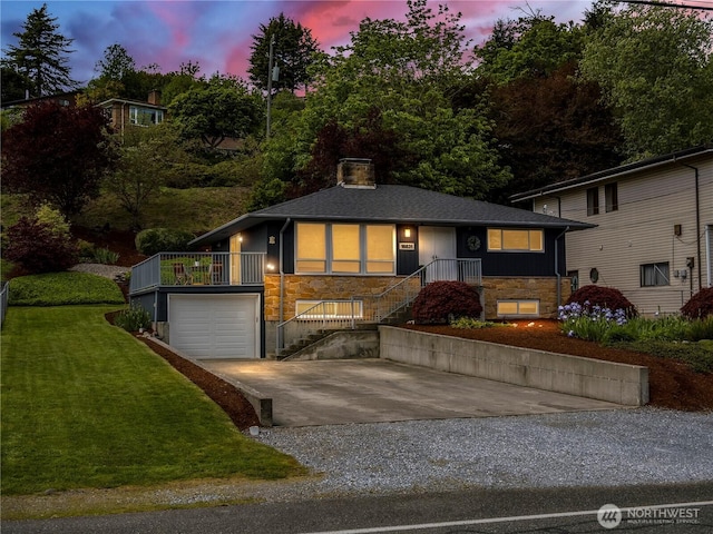 16631 Sylvester Rd SW, Burien, WA 98166 - view of front of property featuring stone siding, driveway, a front lawn, a garage, and stairway