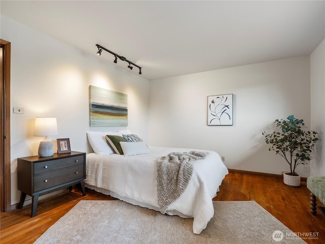 16631 Sylvester Rd SW, Burien, WA 98166 - bedroom featuring track lighting, baseboards, and wood finished floors