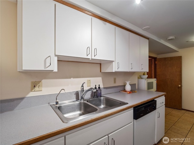 16631 Sylvester Rd SW, Burien, WA 98166 - kitchen featuring white cabinets, light tile patterned flooring, a sink, white appliances, and light countertops