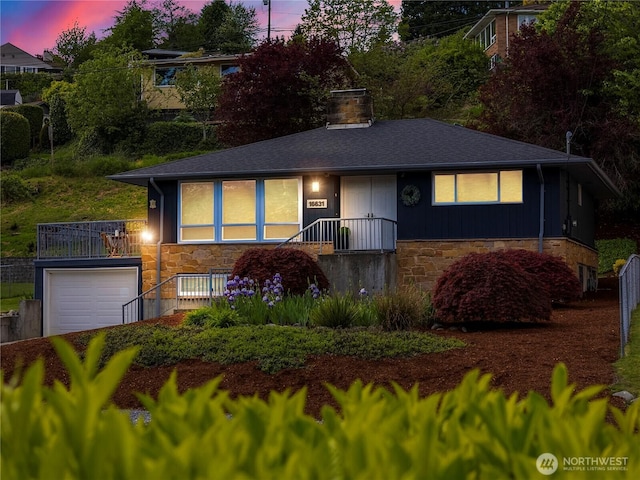 16631 Sylvester Rd SW, Burien, WA 98166 - view of front facade with a chimney, an attached garage, and stone siding