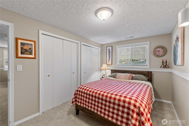 1014 Westmorland Dr, Wenatchee, WA 98801 - carpeted bedroom featuring multiple closets, a textured ceiling, and baseboards