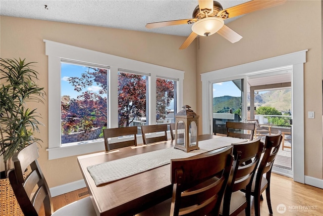 1014 Westmorland Dr, Wenatchee, WA 98801 - dining space featuring vaulted ceiling, baseboards, a ceiling fan, and light wood-style floors