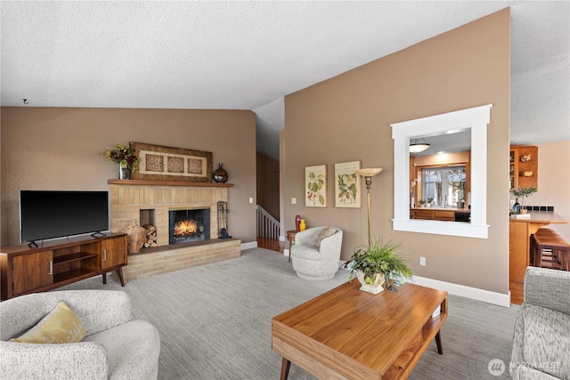 1014 Westmorland Dr, Wenatchee, WA 98801 - carpeted living area with vaulted ceiling, a brick fireplace, baseboards, and a textured ceiling