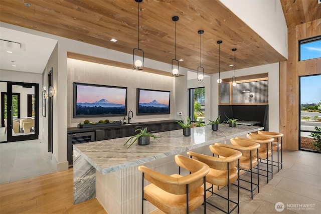 33107SITE142 Liberty Ave SE, Black Diamond, WA 98010 - bar featuring beverage cooler, a sink, wooden ceiling, pendant lighting, and recessed lighting