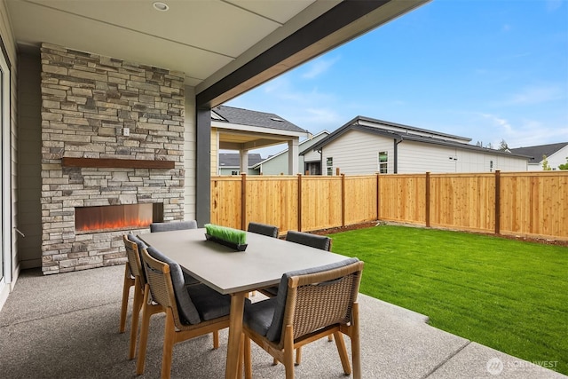 33107SITE142 Liberty Ave SE, Black Diamond, WA 98010 - view of patio / terrace with an outdoor stone fireplace and outdoor dining area