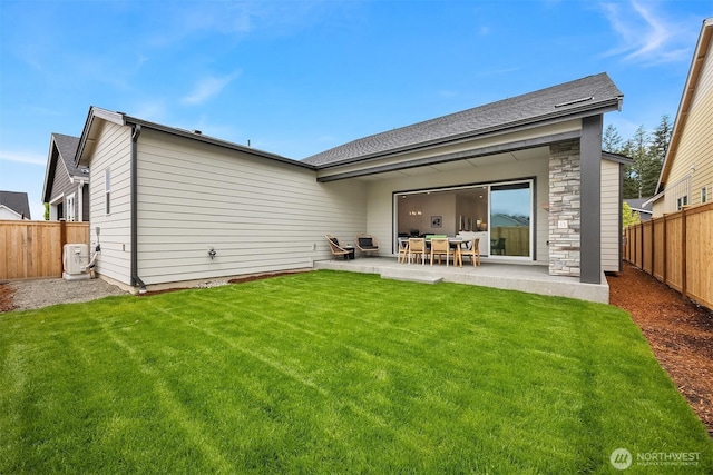 33107SITE142 Liberty Ave SE, Black Diamond, WA 98010 - rear view of house featuring a patio area, stone siding, and ac unit