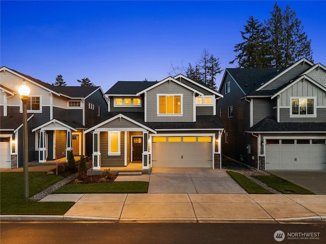 view of front facade with an attached garage, a yard, and driveway