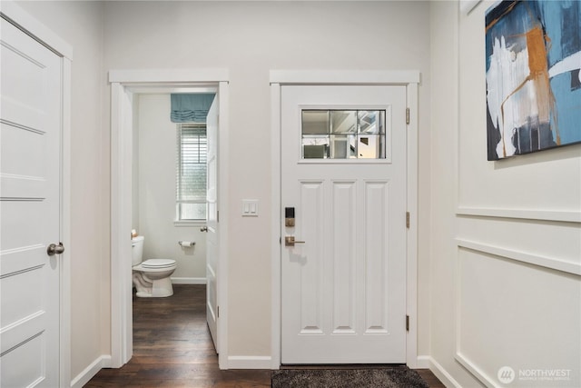 entryway with baseboards and dark wood-style floors