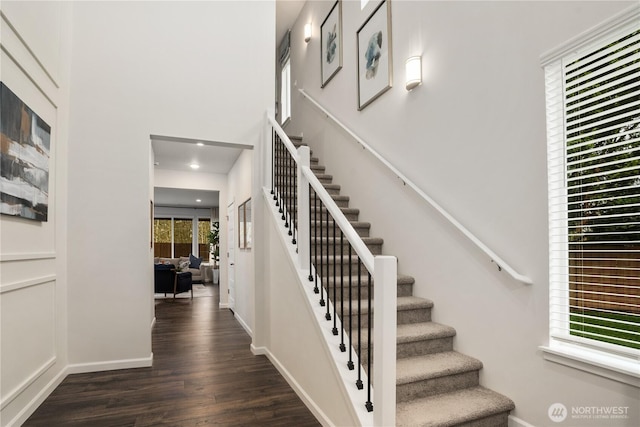 stairway featuring baseboards, recessed lighting, and wood finished floors