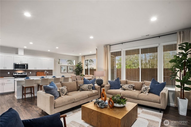 living room featuring recessed lighting, visible vents, and wood finished floors