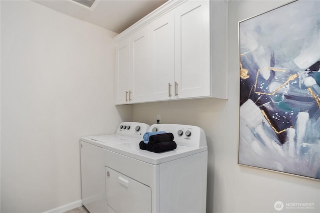 laundry room featuring cabinet space, visible vents, and washing machine and dryer