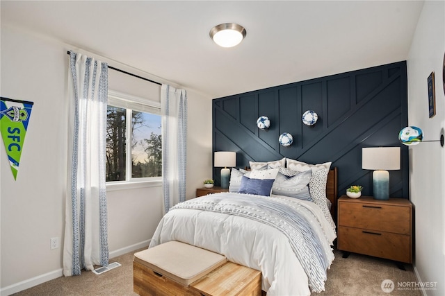 bedroom with carpet floors, baseboards, and visible vents