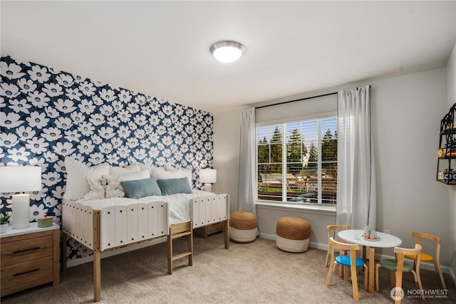 carpeted bedroom featuring baseboards, an accent wall, and wallpapered walls