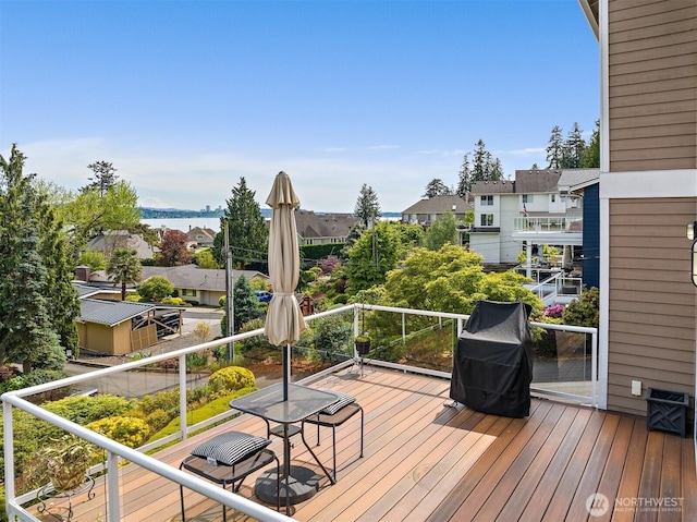 wooden deck featuring a residential view and area for grilling