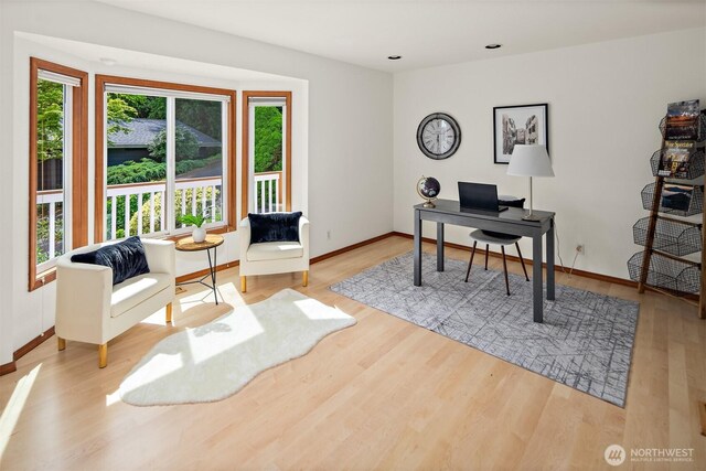 office with plenty of natural light, wood finished floors, baseboards, and recessed lighting