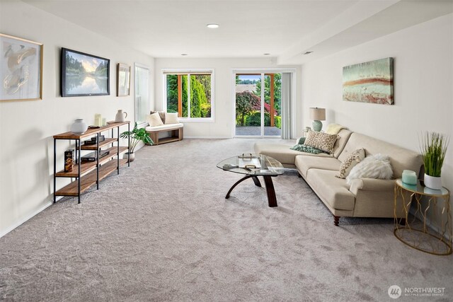 carpeted living room with baseboards