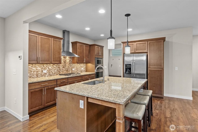 3530 128th St SE, Everett, WA 98208 - kitchen with wall chimney exhaust hood, appliances with stainless steel finishes, baseboards, a kitchen island with sink, and dark wood-style flooring