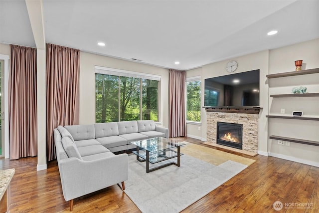 3530 128th St SE, Everett, WA 98208 - living area with wood finished floors, a stone fireplace, recessed lighting, and baseboards