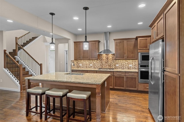 3530 128th St SE, Everett, WA 98208 - kitchen featuring a sink, wall chimney range hood, appliances with stainless steel finishes, dark wood-style flooring, and recessed lighting